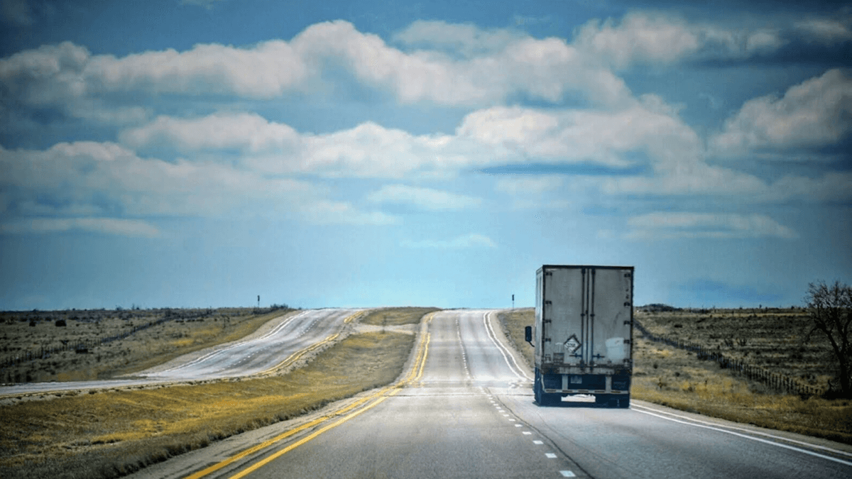 Semi-truck driving on highway representing logistics and transportation marketing